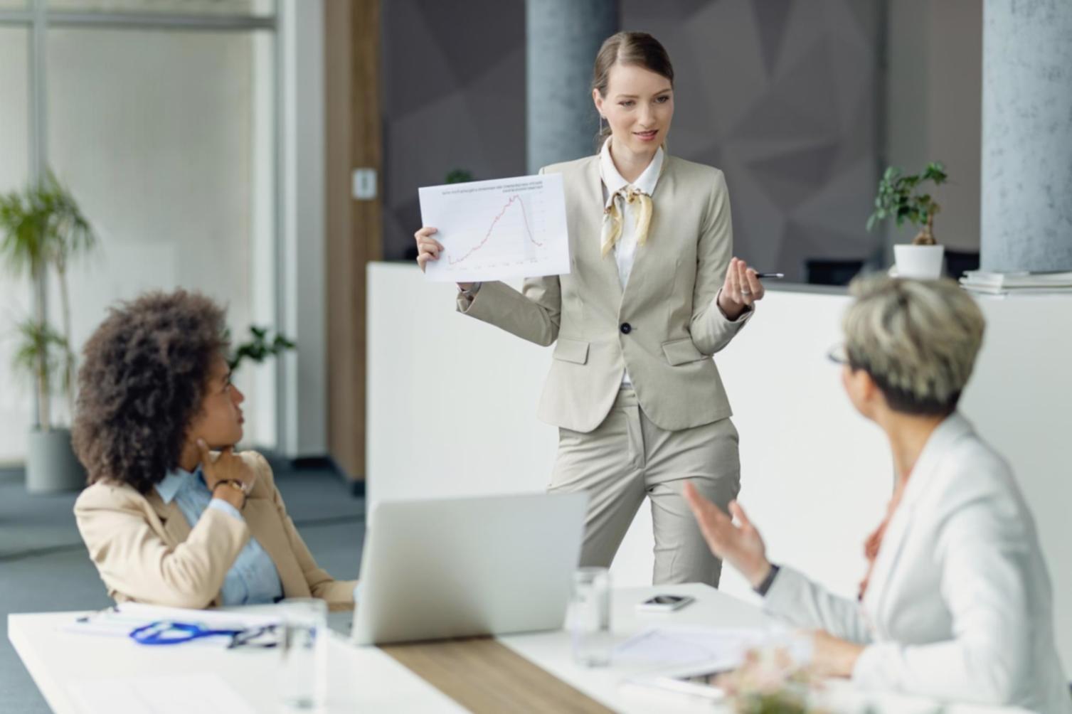 Business professionals analyzing financial charts and presentation slides in a modern Australian office environment