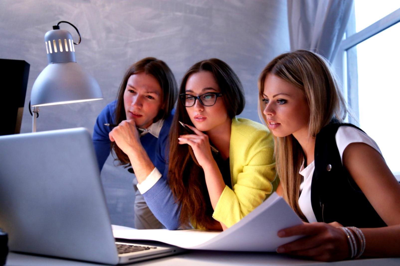 Small group of professionals collaborating on financial presentation materials