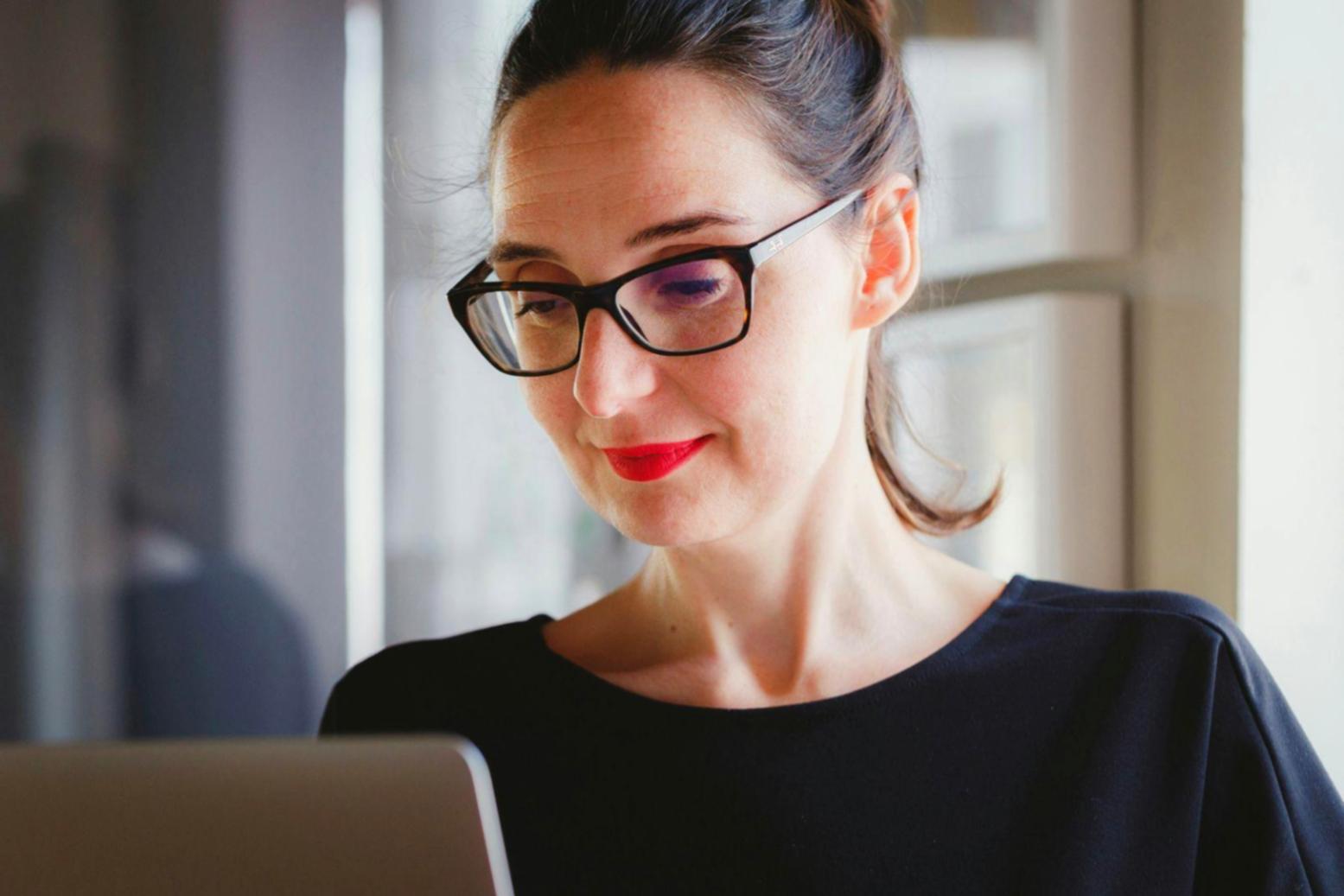 Modern conference room with presentation setup and financial charts on screen